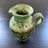 Old pitcher with ethnic decor
