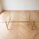 Vintage coffee table with glass and gold metal.