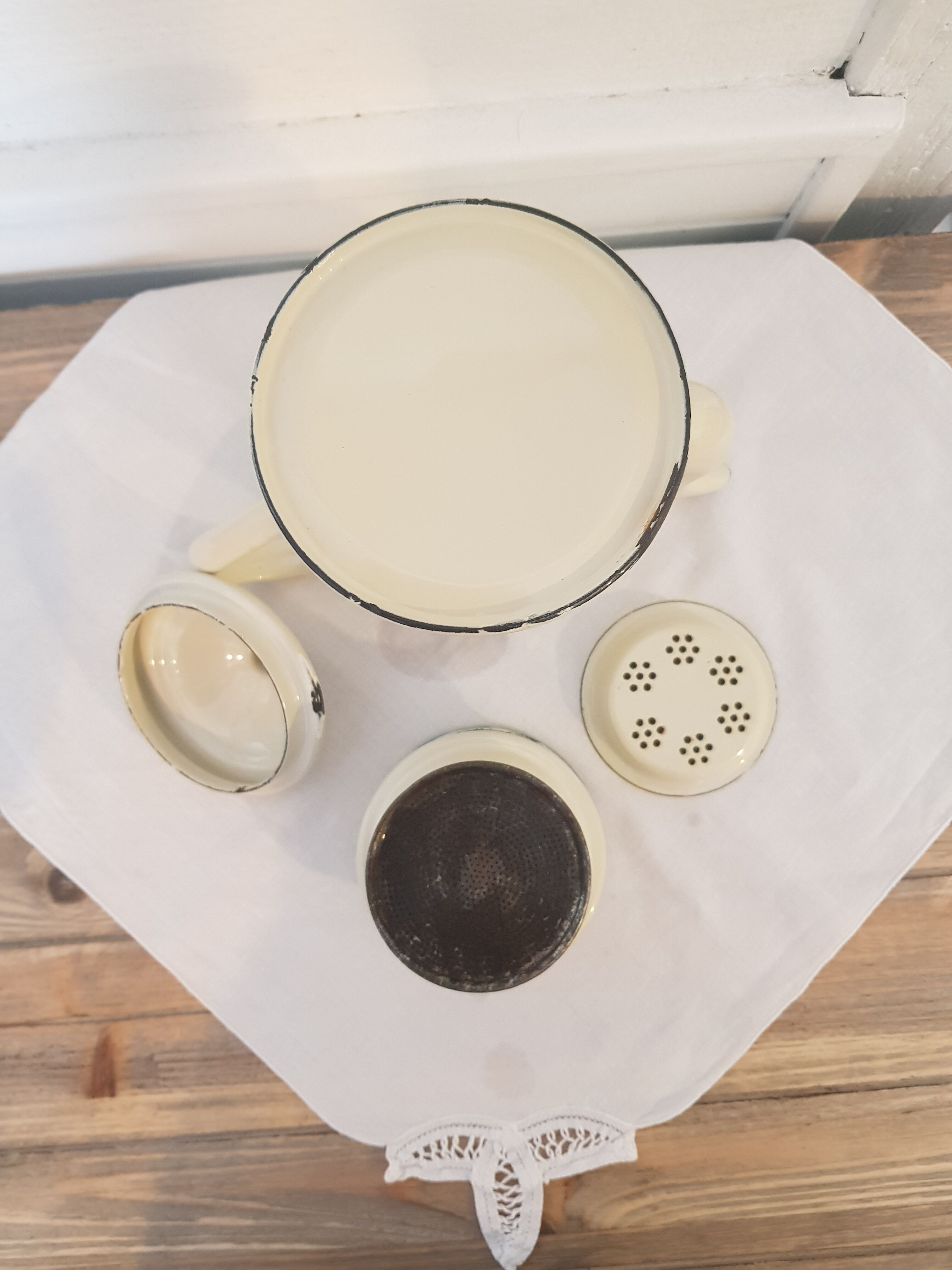 Old pale yellow enamelled coffee maker with filters