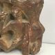 Plaster sculpture depicting a group of 3 figures