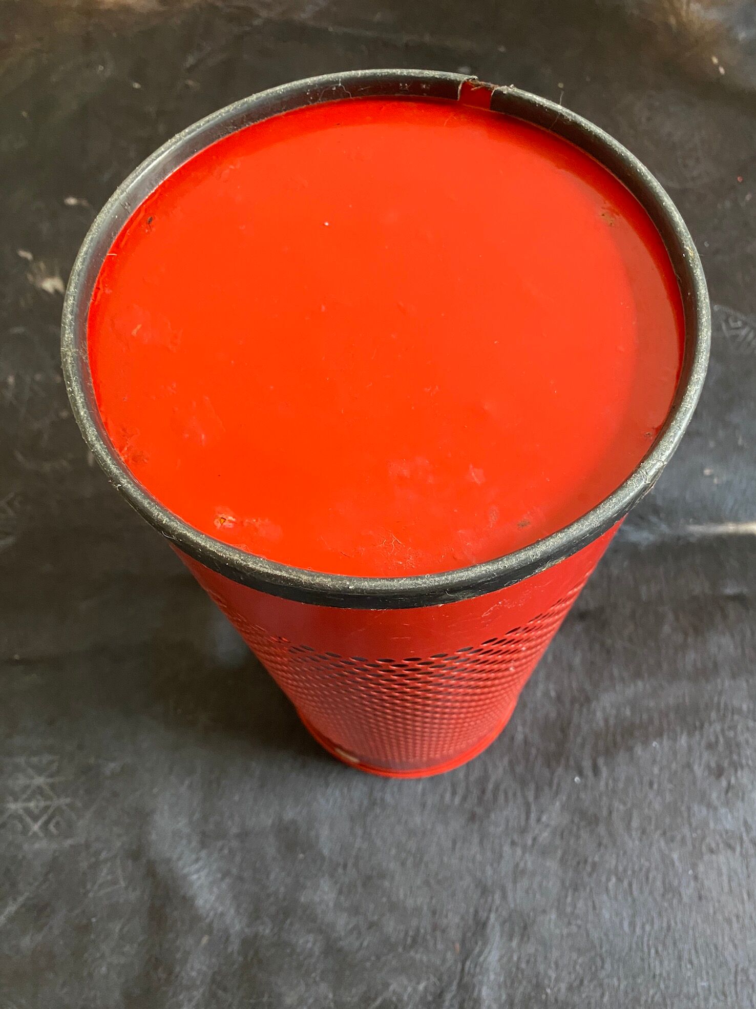 Vintage red umbrella holder in 80s perforated sheet metal or Italy trash can