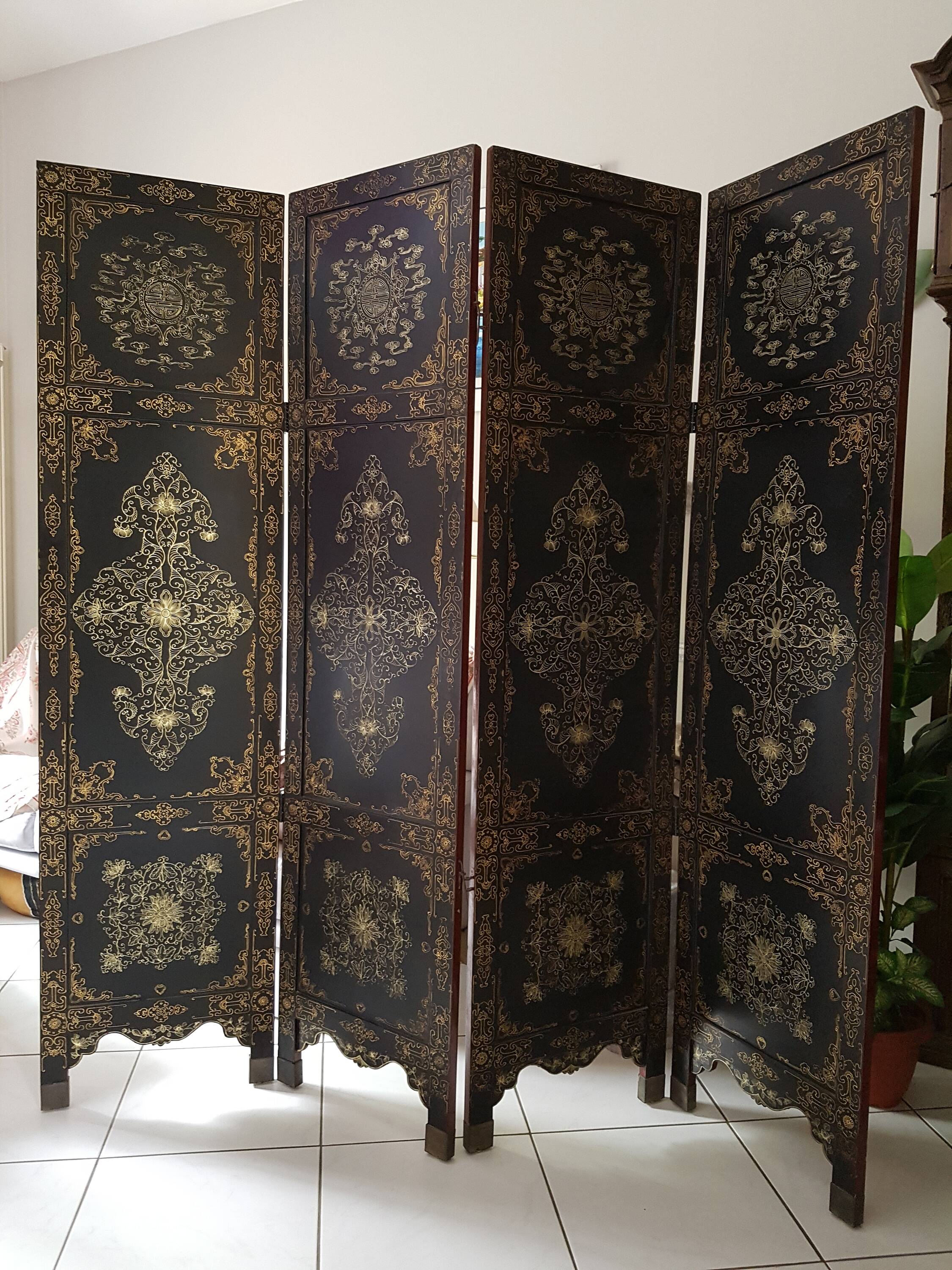 Four-panel Japanese-style screen in red and gold lacquer.