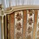 Louis XVI style bed in patinated wood with fluted columns.