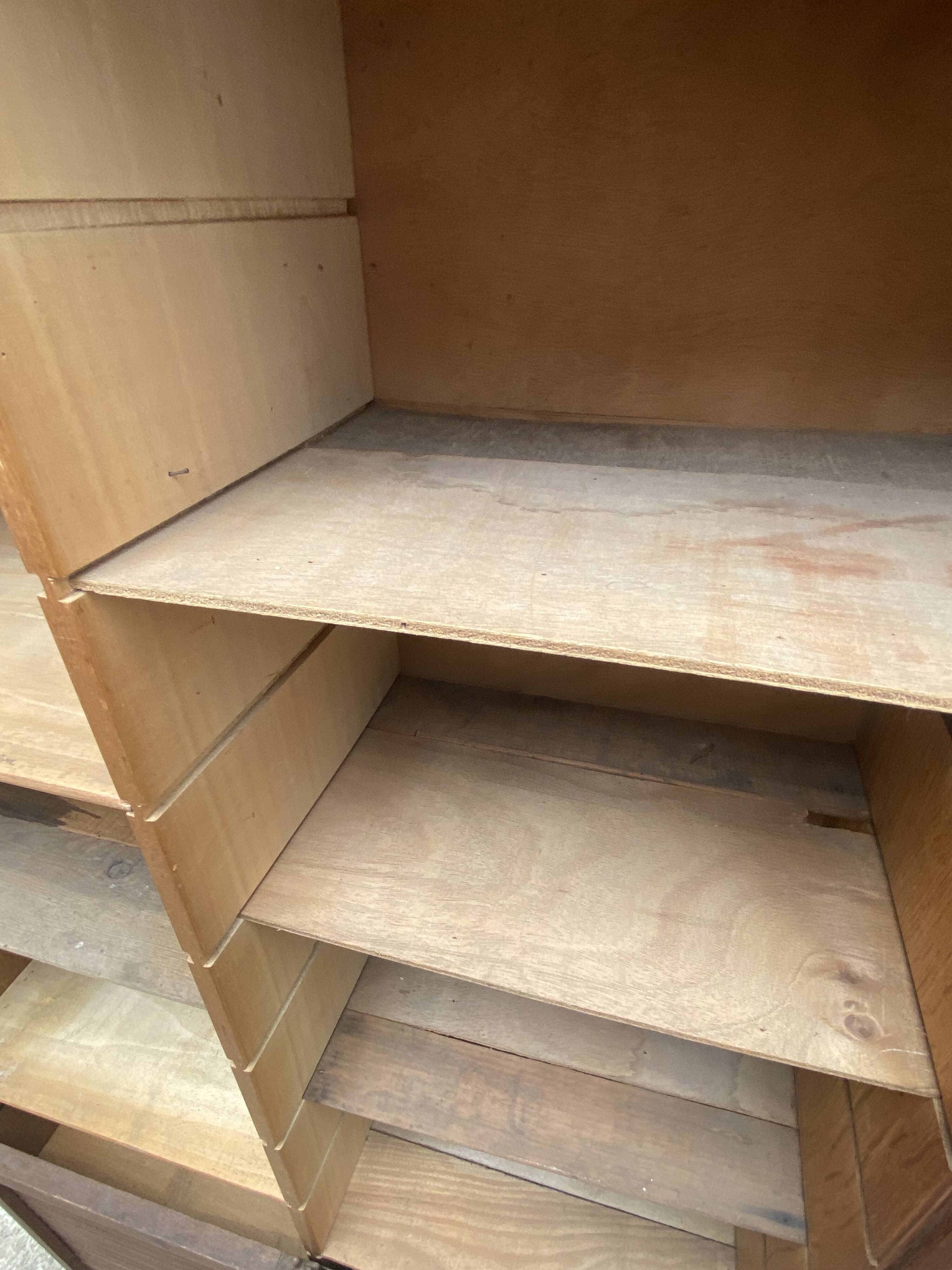 Oak two-column filing cabinet with curtains.