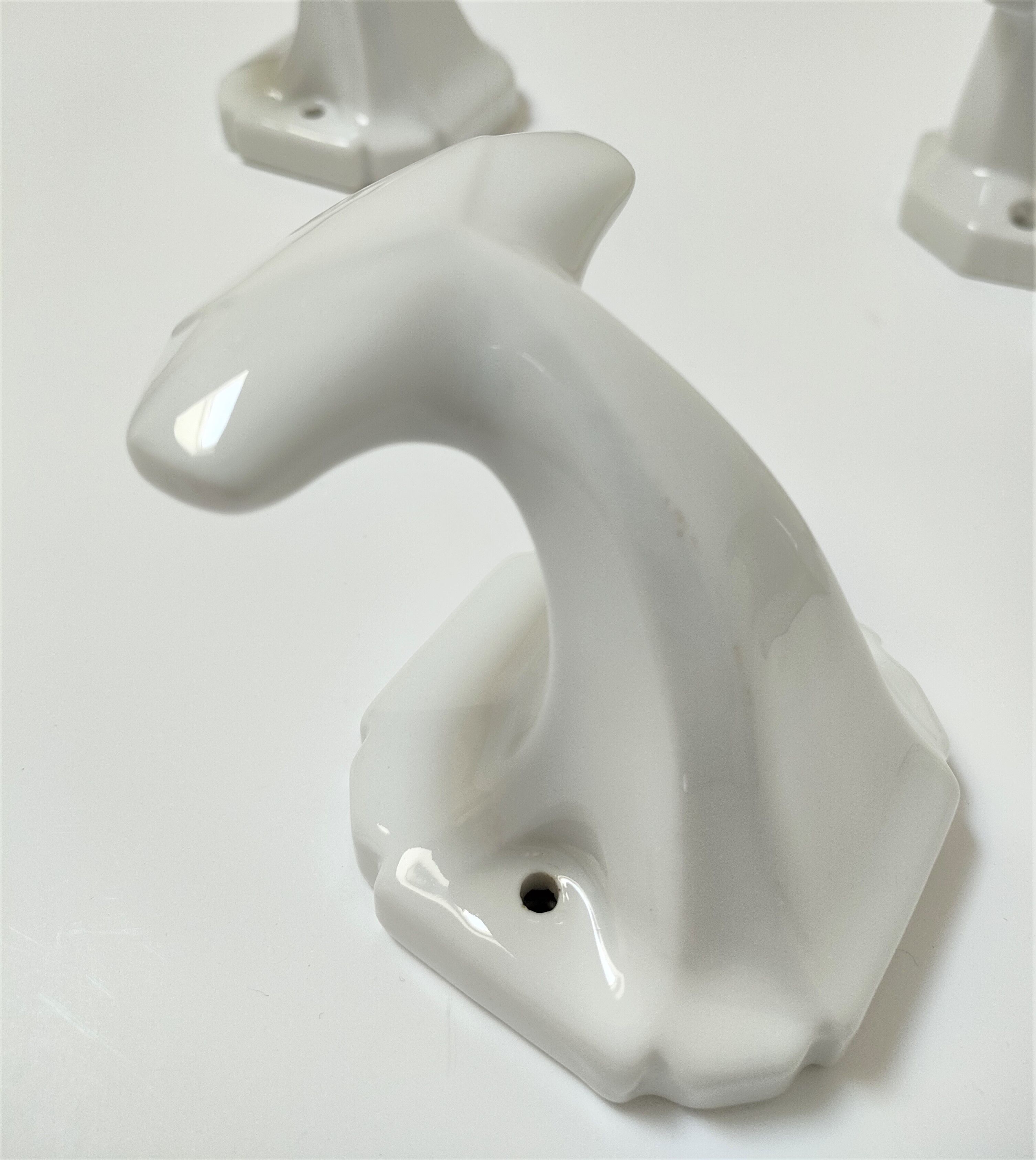 Five art deco white porcelain hooks