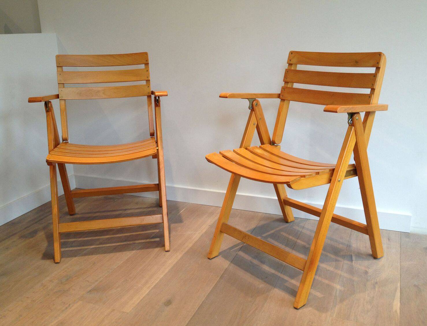 Pair of varnished wooden folding armchairs signed Clairitex.