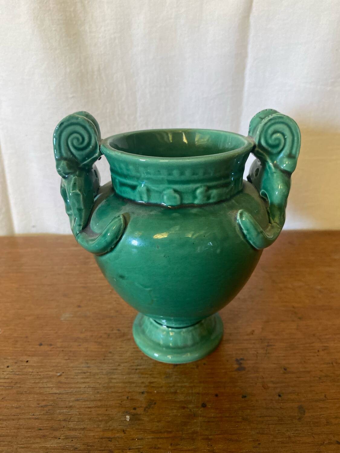 Antique green ceramic vase with handles