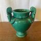 Antique green ceramic vase with handles