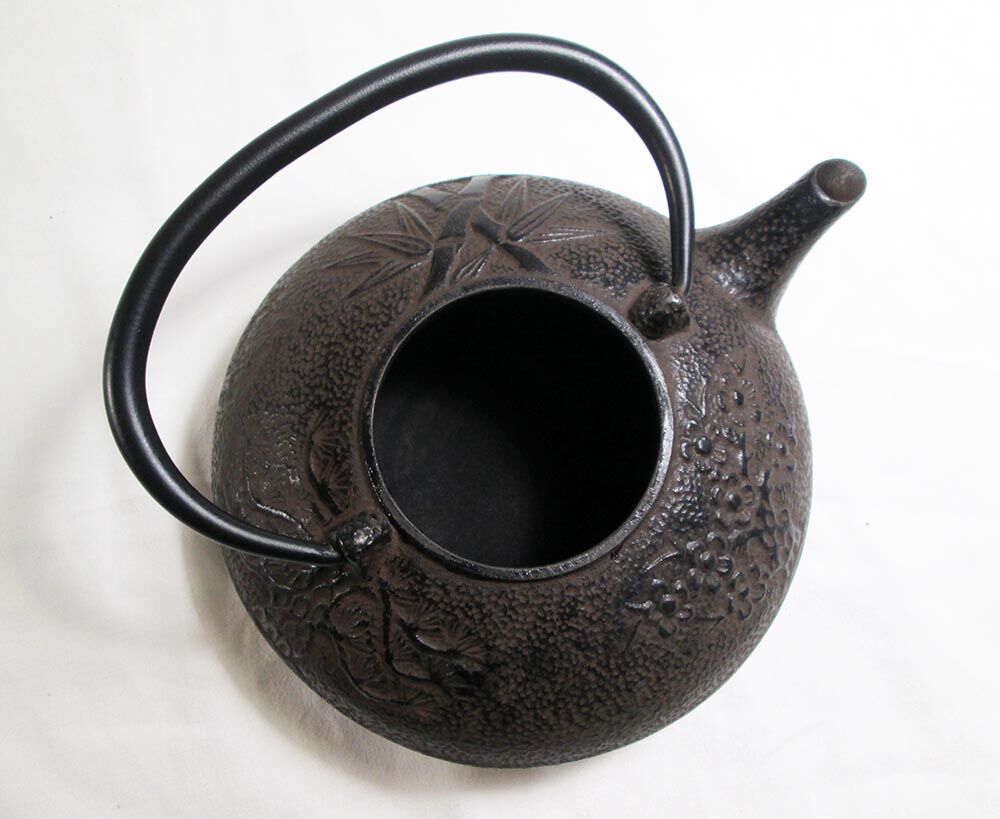 Antique cast iron teapot decorated
