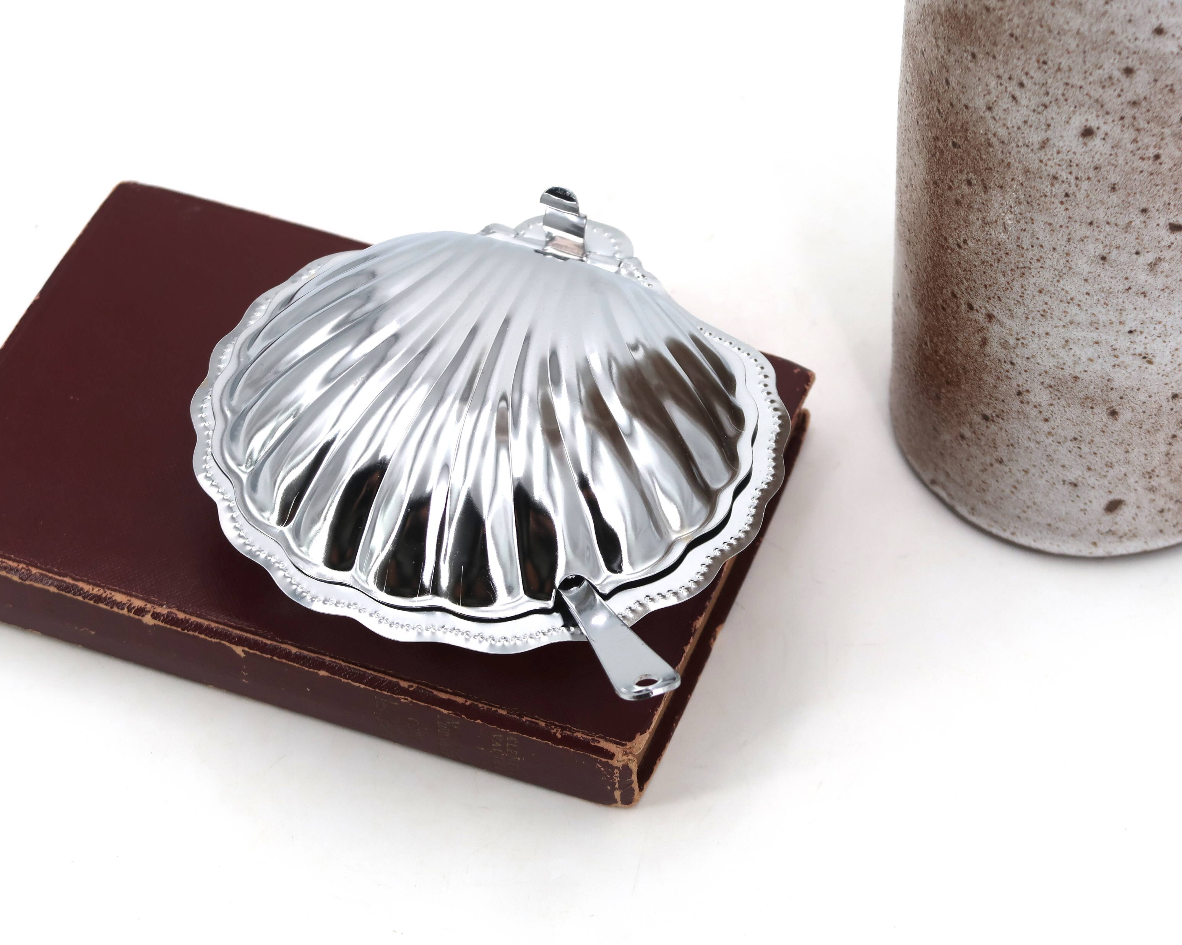 Silver-plated metal and glass shell-shaped butter dish with its knife.
