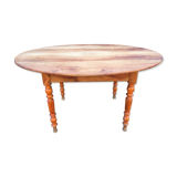 Table ovale ancienne en cerisier à piétement parapluie.