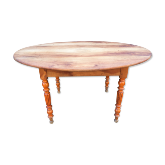 Old oval cherry tree table with umbrella base.
