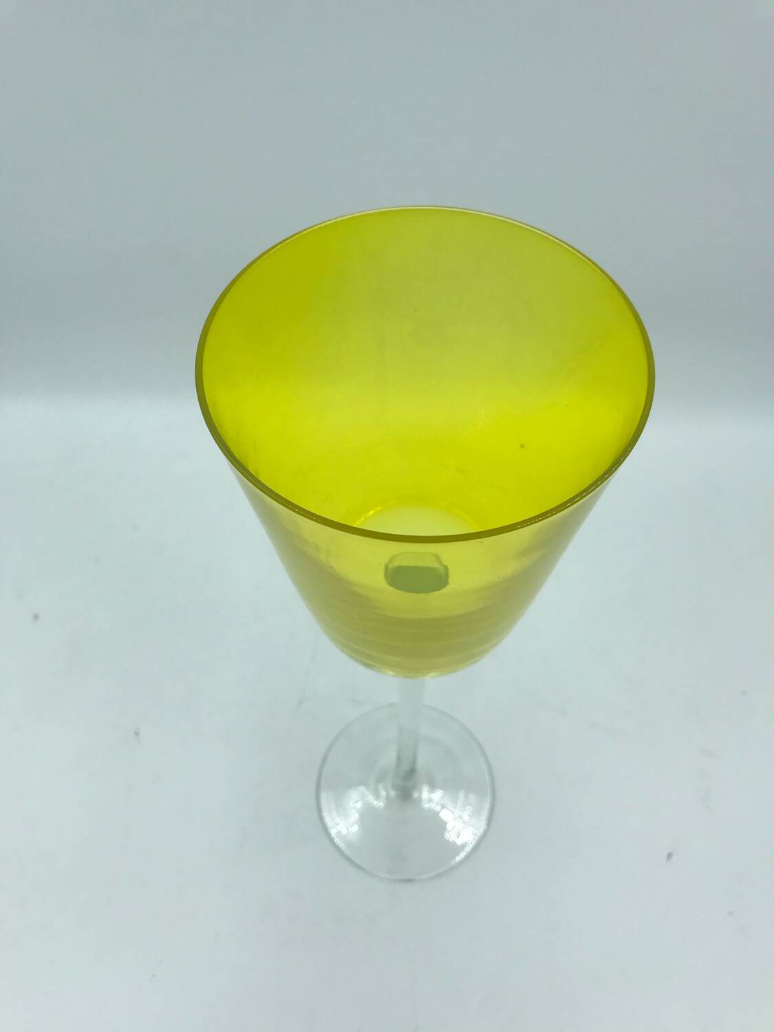 Yellow glass candlestick on a stand