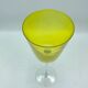 Yellow glass candlestick on a stand