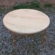 Round neoclassical coffee table with a marble top and golden metal base.