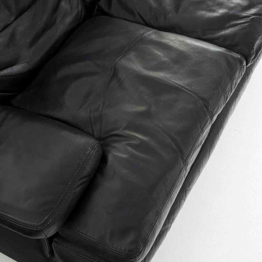 Black leather two-seater sofa. Roche Bobois edition. France, 1980s.