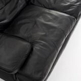 Black leather two-seater sofa. Roche Bobois edition. France, 1980s.