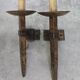 Pair of brutalist wall sconces in hammered and patinated iron, work from the years.