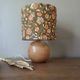Table lamp with a wooden ball base, floral print in bohemian style.