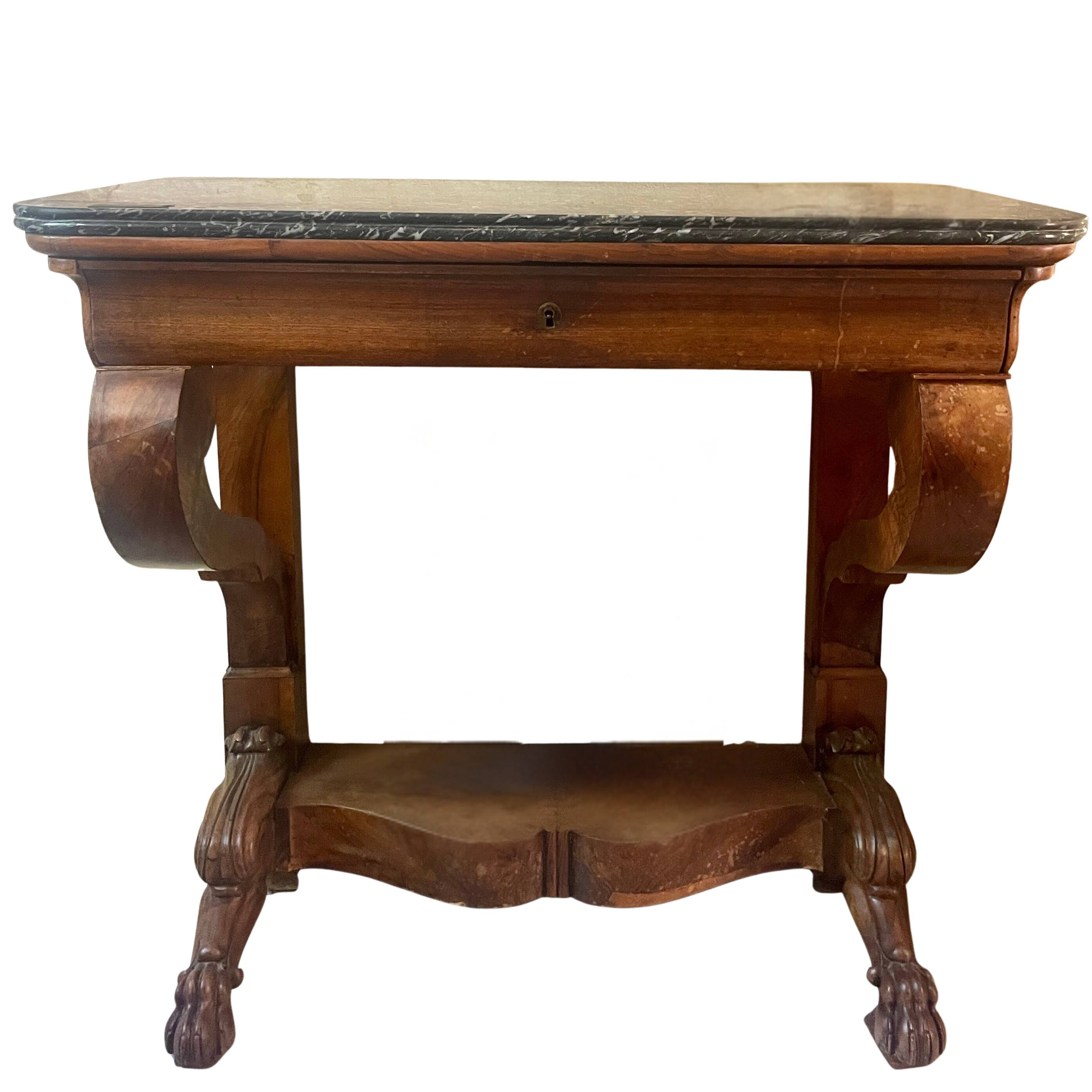 Console inlaid with black marble and lion's paw legs.