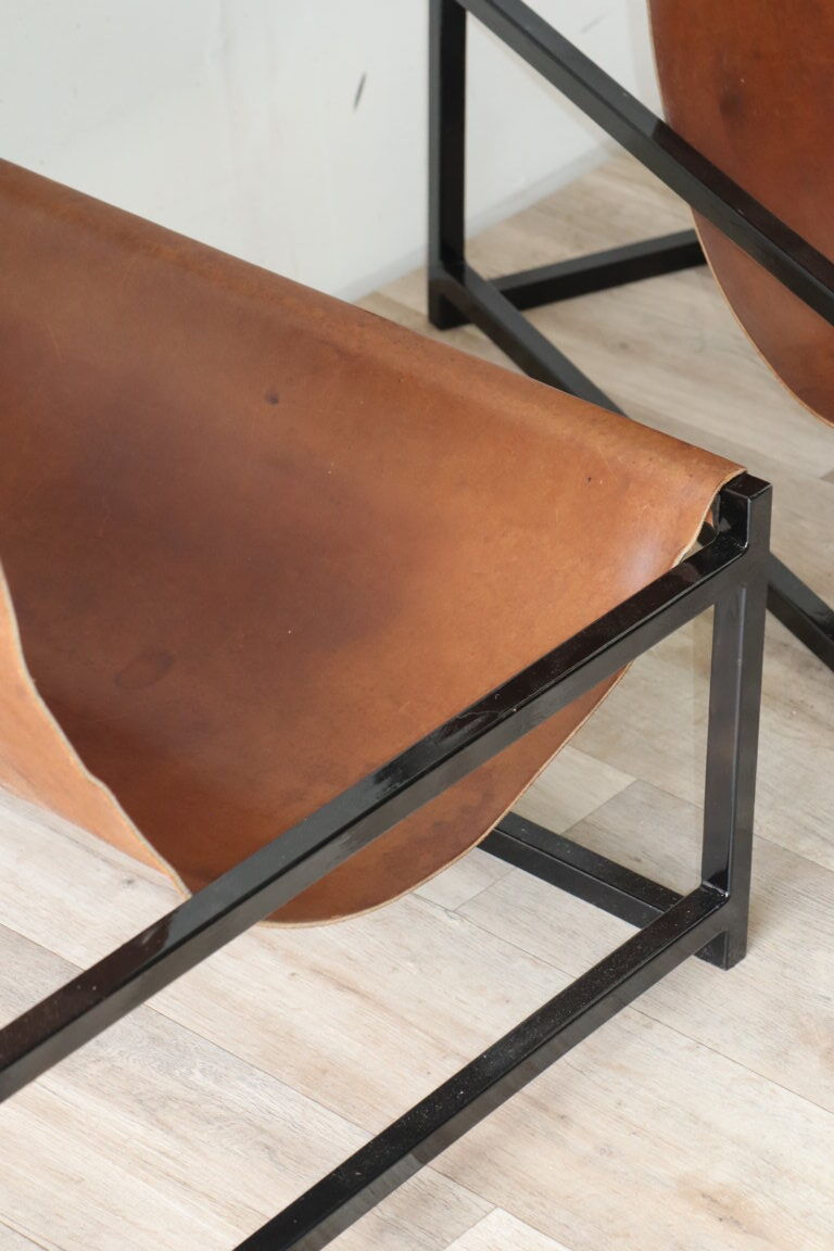Pair of vintage armchairs in stretched leather and metal structure