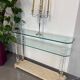 Hollywood Regency console style in travertine, glass, and Lucite.