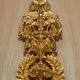 Pair of L'Originale wall sconces plated with 24-carat gold featuring four bronze candles.