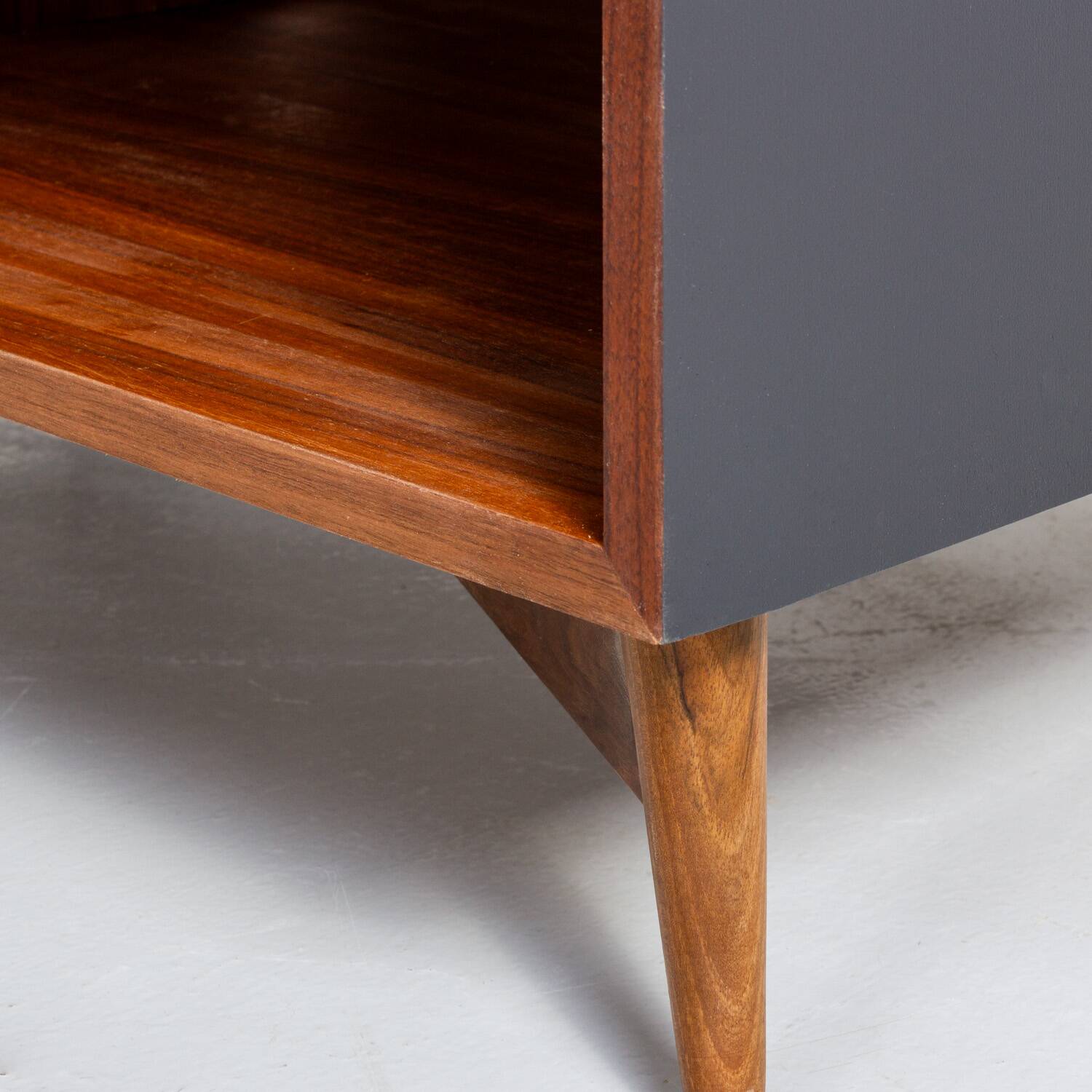 Chest of drawers in walnut and black paint, solid walnut base