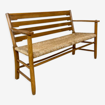 Vintage wooden farmhouse bench with cane seat