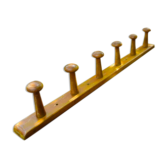 Wall coat rack in colored wood.