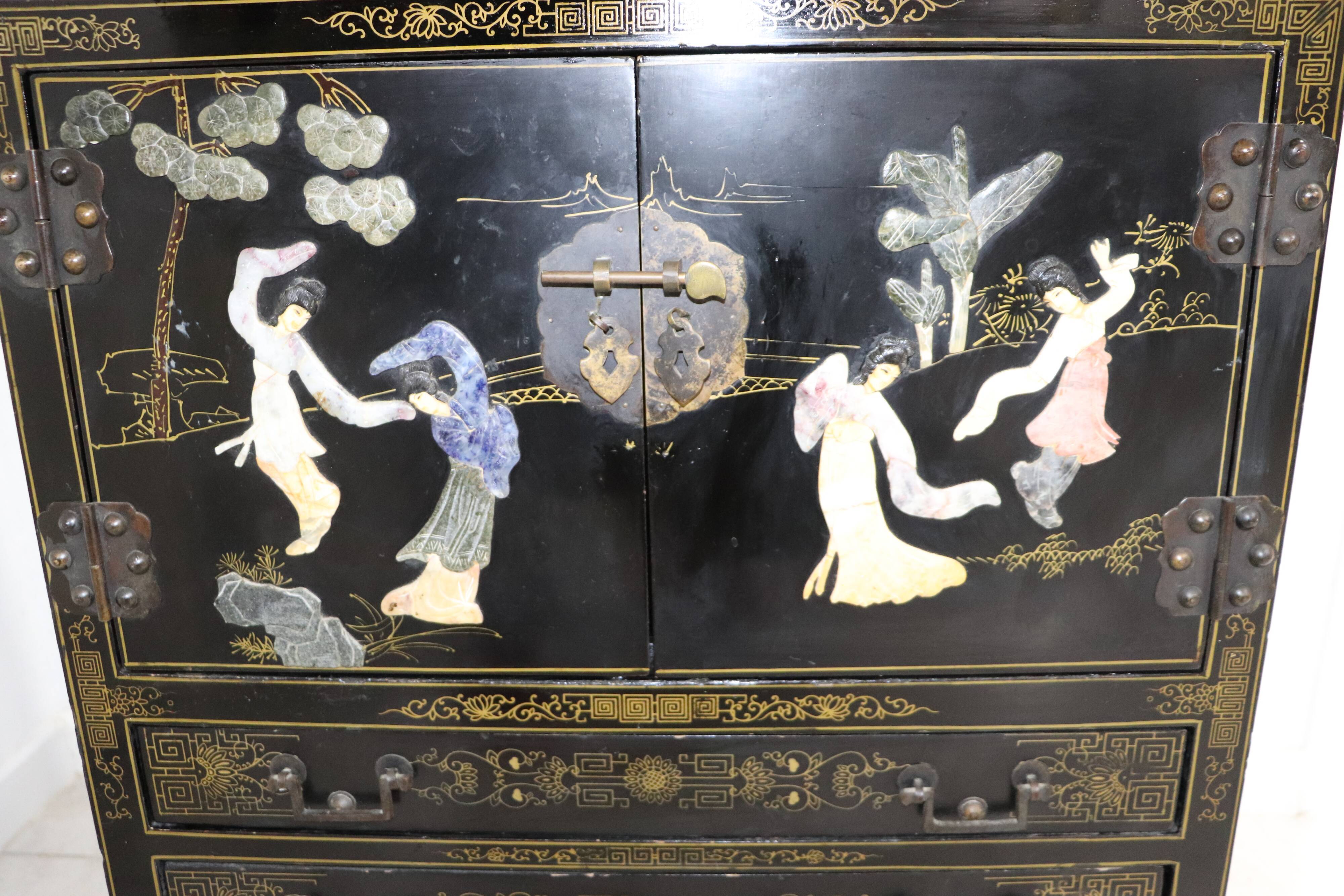Black lacquered Chinese buffet with stone and ivory figures