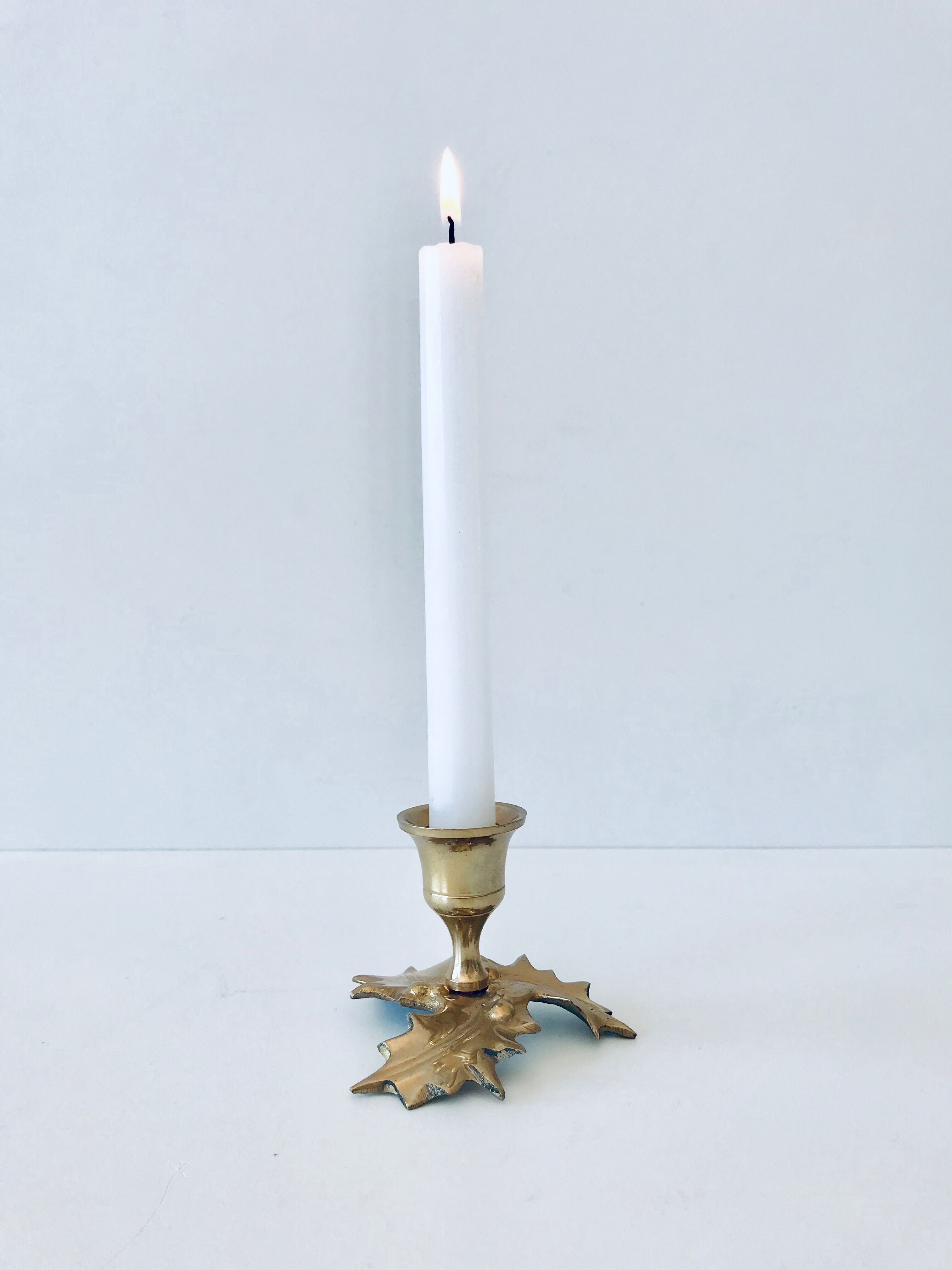 Candlestick in brass holly design
