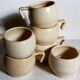 Six vintage potter's ceramic cups with vanilla enamel