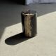 Small side table in black petrified wood with stripes and beige sides H28 D18.