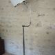 Flexible floor lamp, chrome, opaque white shade with metallic edges.