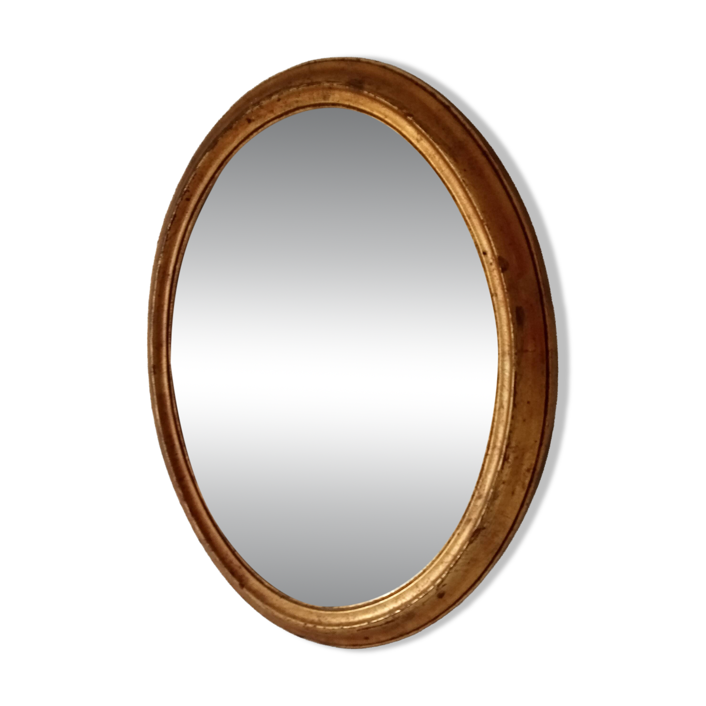 Antique oval mirror in gilded solid wood