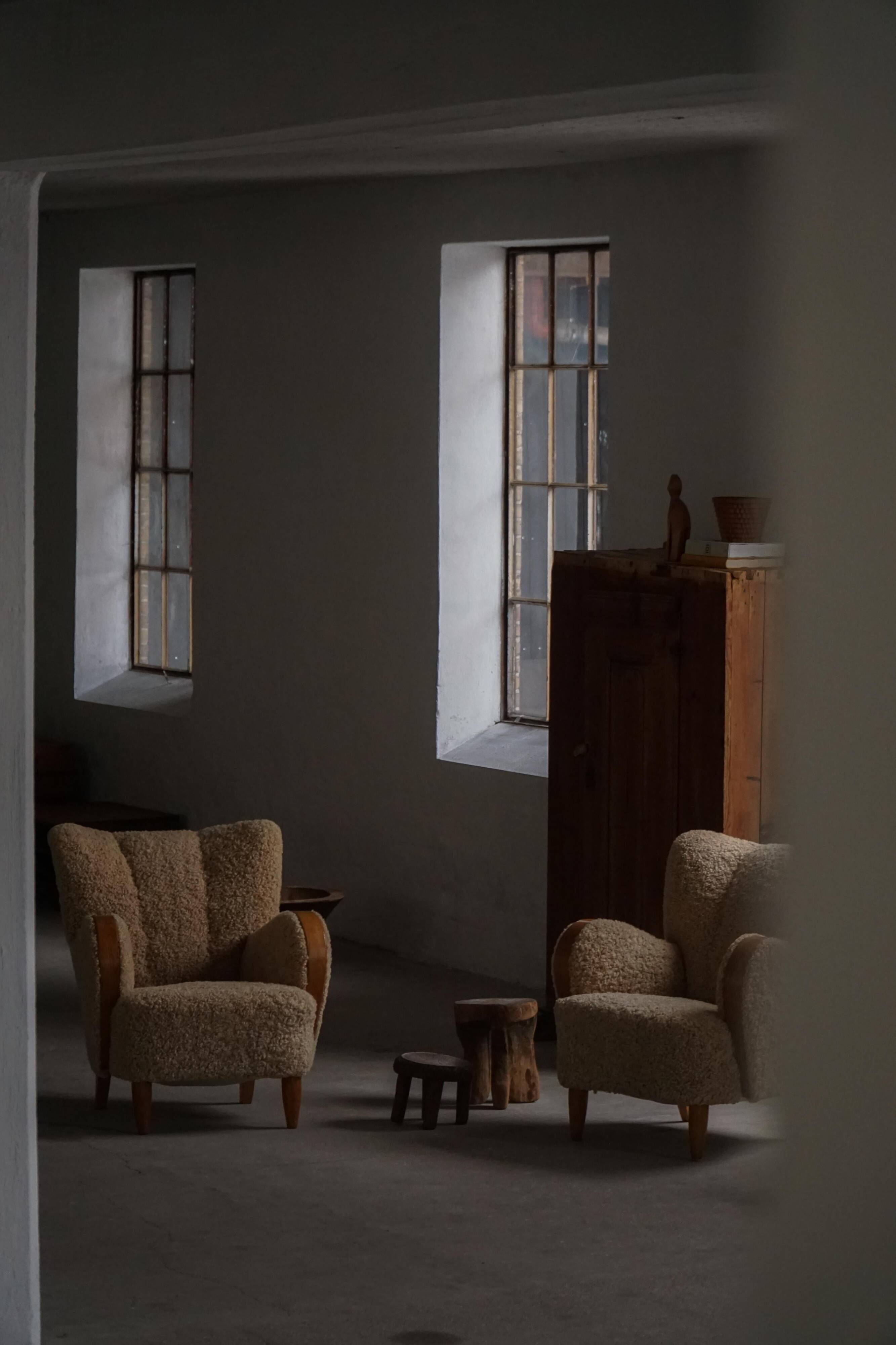 Pair of Danish Art Deco modern lounge chairs in sheepskin with lambswool and elm, 1940s.