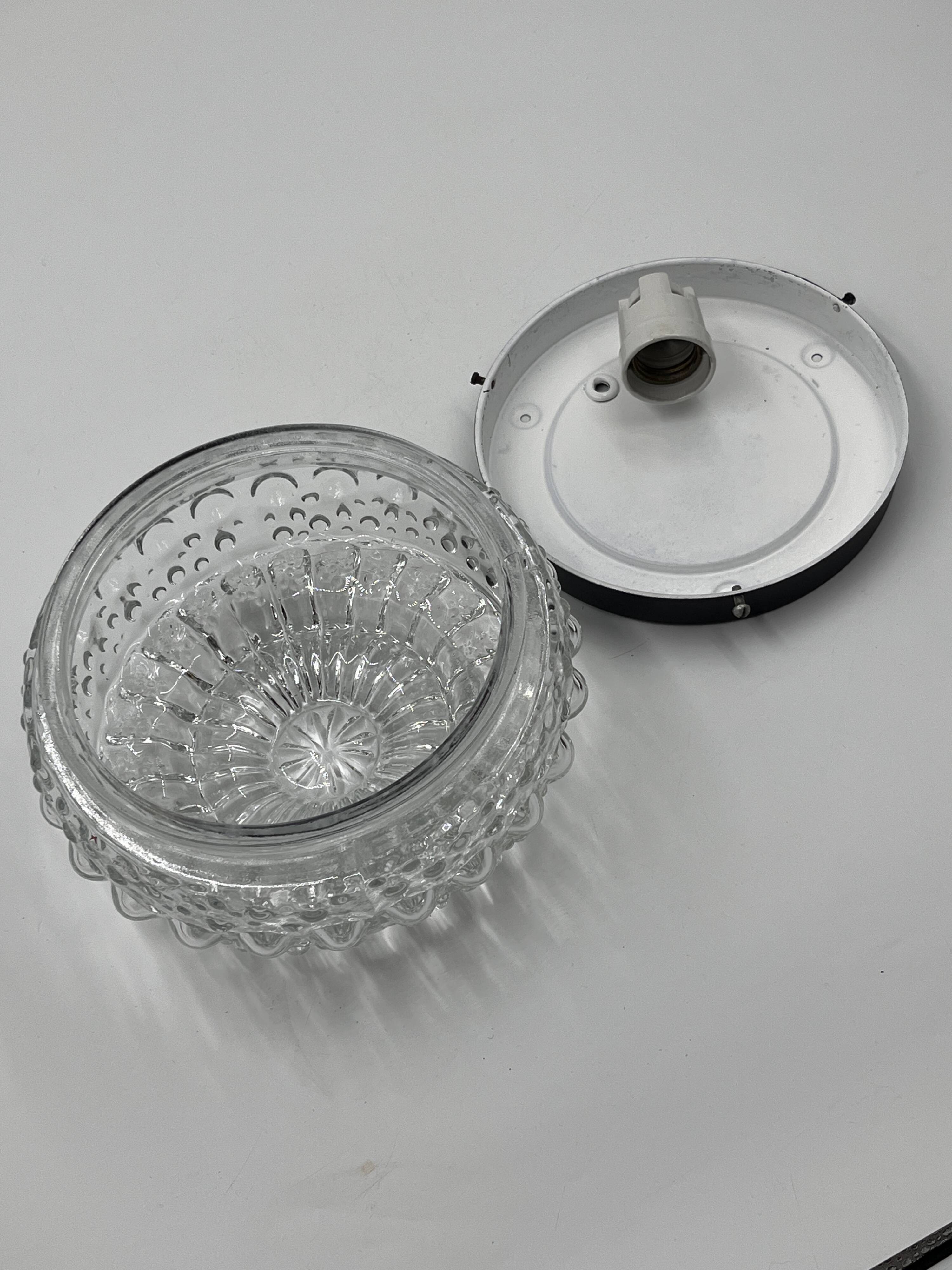 Molded glass ceiling light with spinning top relief