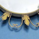 Circular gold metal mirror with floral decoration – 1960s