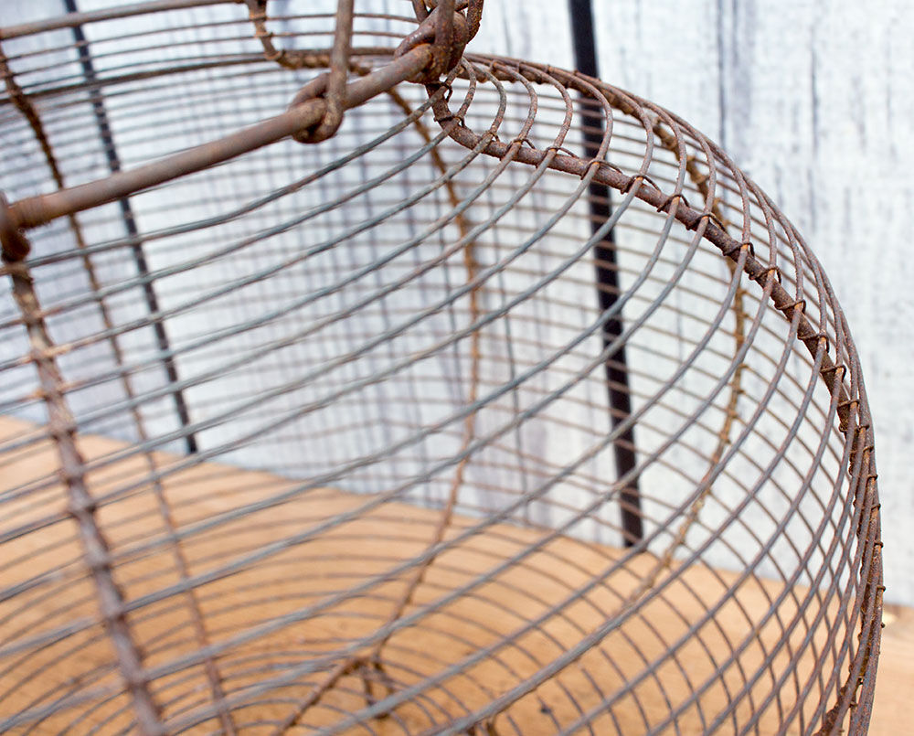 Old basket has wire eggs