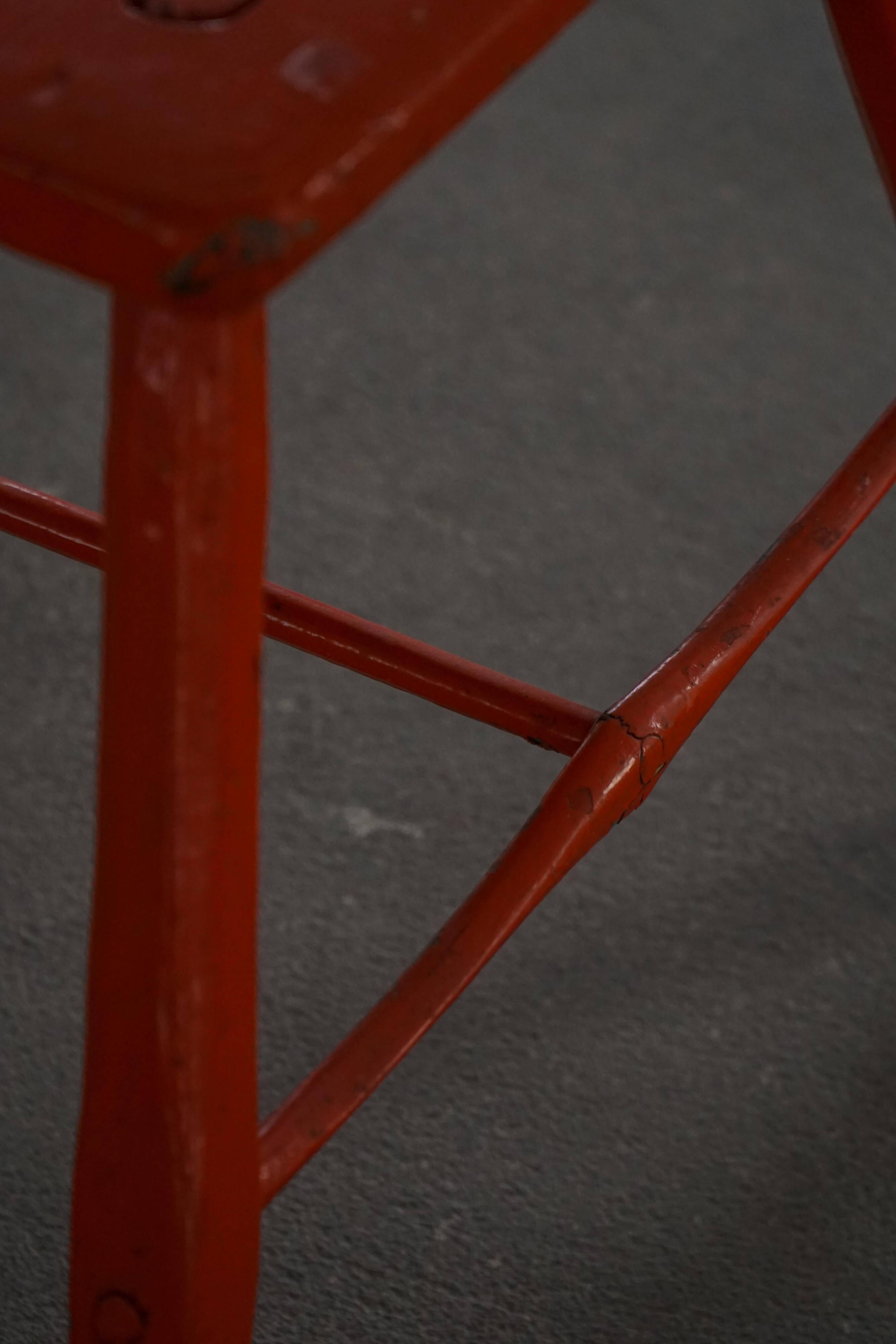 Pair of patinated wooden stools painted red with flared legs, 1950s-1960s.