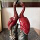 Pair of ceramic red glazed wading bird (crane) figurines.