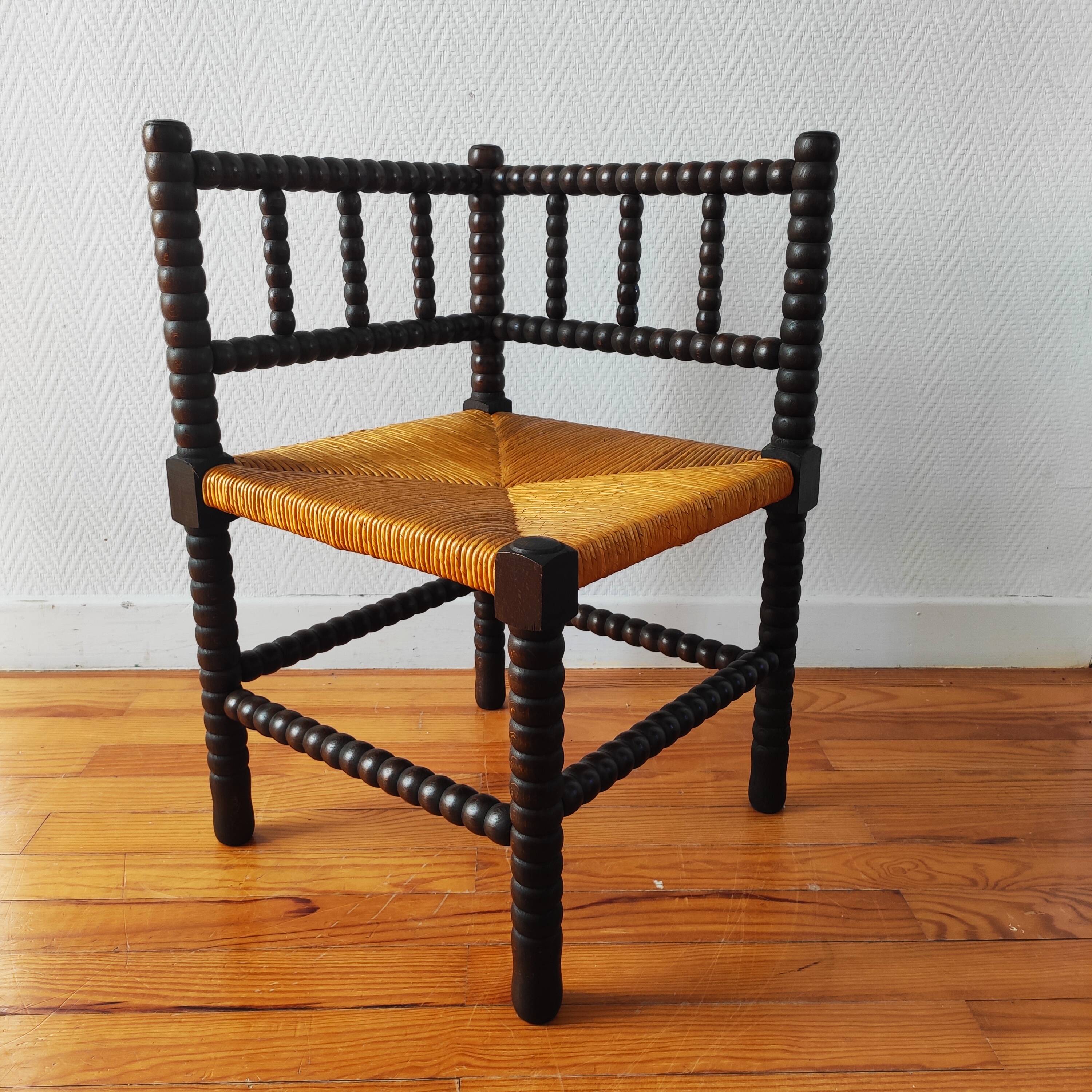 Antique corner chair made of turned wood.