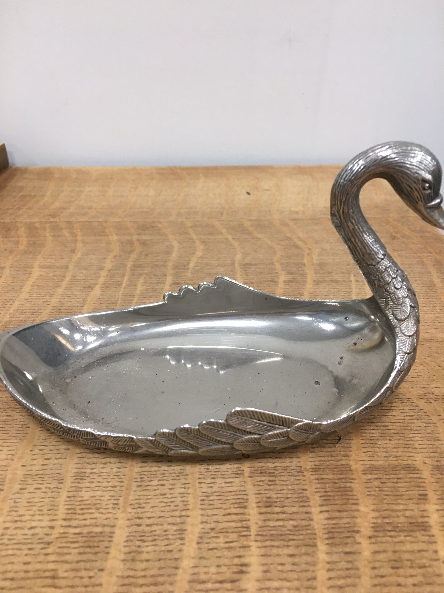 Empty silver metal swan pocket