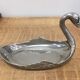 Empty silver metal swan pocket