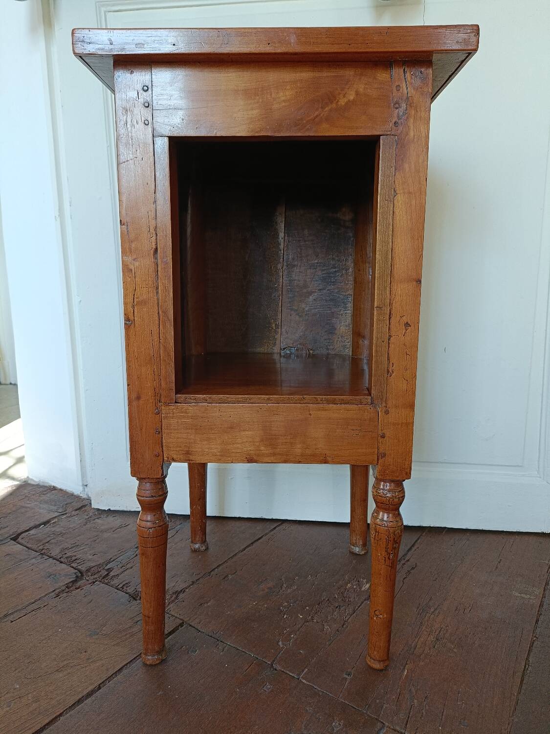 Open wooden bedside table