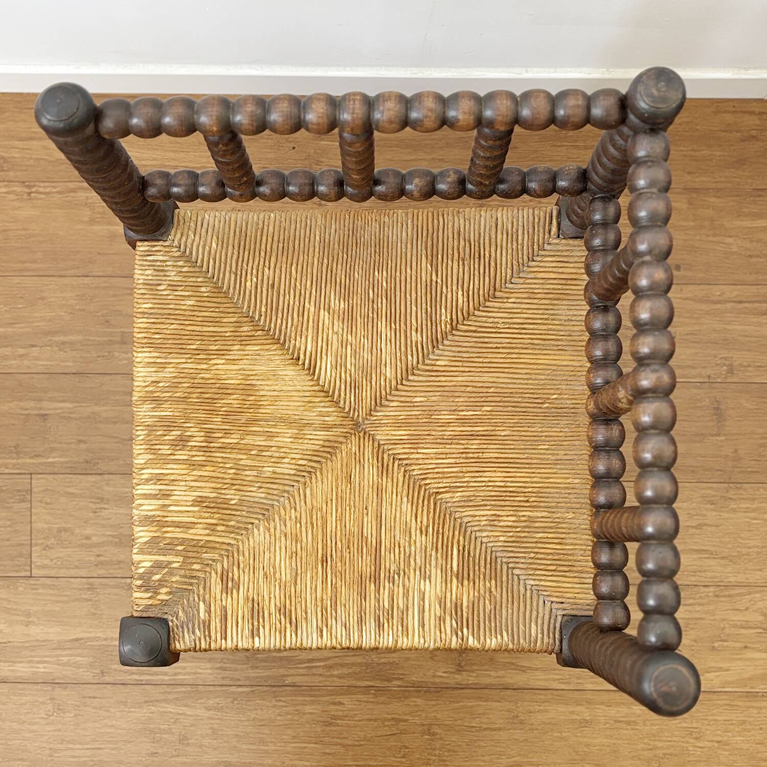 Turned wood corner chair with straw seat