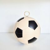 Vintage cigarette dispenser in the shape of a football.