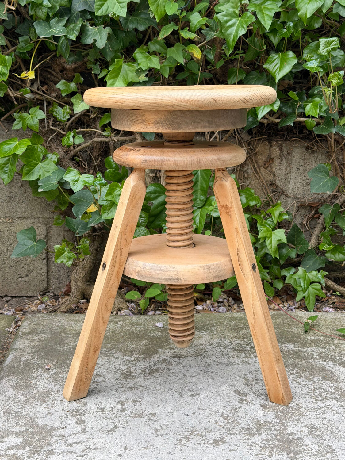 1950s solid oak tripod workshop stool with a screw mechanism.