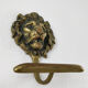 Pair of brass lion head patères